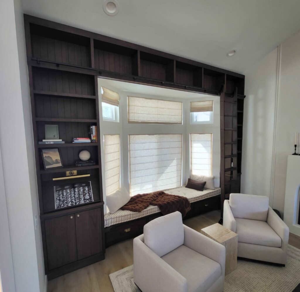 Custom built-in reading nook with shelves and storage cabinets in Houston home