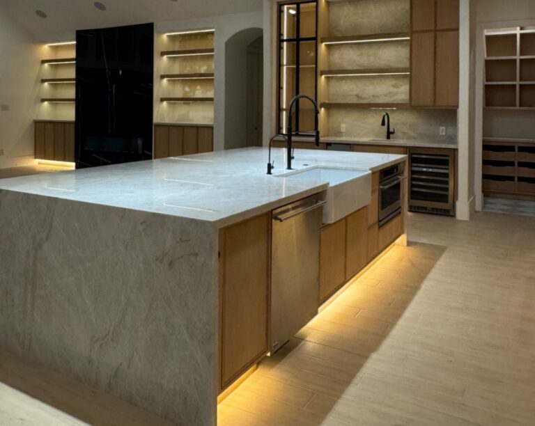 Kitchen remodeling with custom wood cabinets, large stone island, open shelves, and LED lighting in Houston home